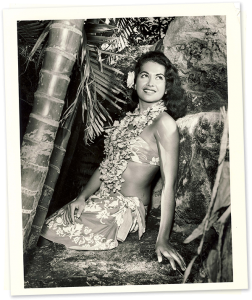 Vintage photo of owner Mireille Thornton - sarong clad and posed gracefully in the gardens.