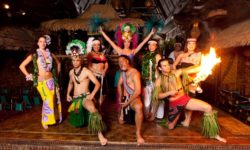 The Mai-Kai Polynesian Revue posing with fire on the stage of the Mai-Kai.