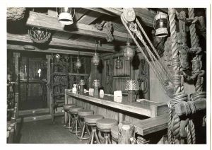 Historic photo of the upper level of the Molokai Bar with its wooden beams, ship ropes, and nautical artifacts.