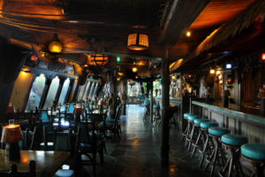 Long galley view of the Molokai Bar which is designed as a turn-of-the-century seaport saloon.
