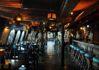 Long galley view of the Molokai Bar which is designed as a turn-of-the-century seaport saloon.
