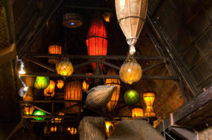 Dozens of brightly colored nautical themed lanterns glowing against the traditional thatched ceilings of the Mai-Kai.