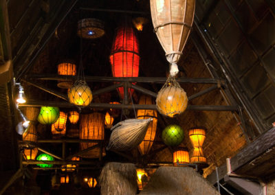 Dozens of brightly colored nautical themed lanterns glowing against the traditional thatched ceilings of the Mai-Kai.