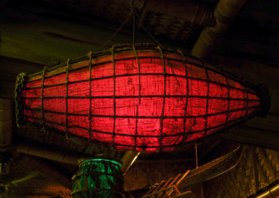 A close up of a nautical themed lantern with a warm red glow - one of many lanterns suspended from the Mai-Kai ceilings.
