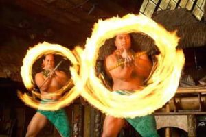 Two Male Polynesian fire dancers creating two simultaneous rings of fire with a dramatic flair.