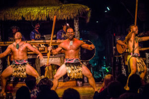 Three Male Polynesian dancers performing the Haka dance on Mai-Kai stage.