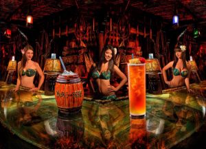 Sarong clad Mai-Kai bartenders proudly present the Barrel O’Rum and Planters Punch in the Molokai Bar.